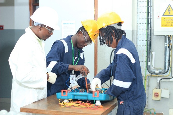 Trainees building a control circuit on a training board