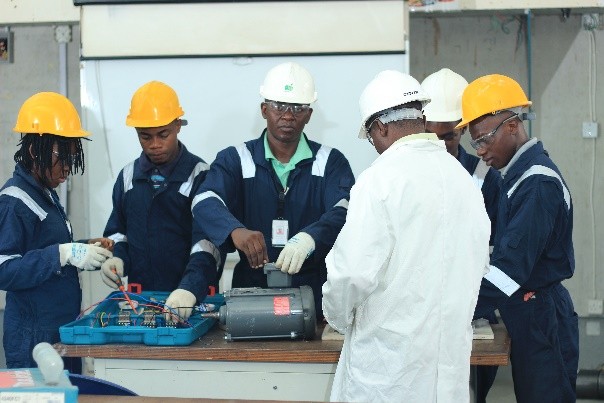 Trainees testing an electric motor with an instructor