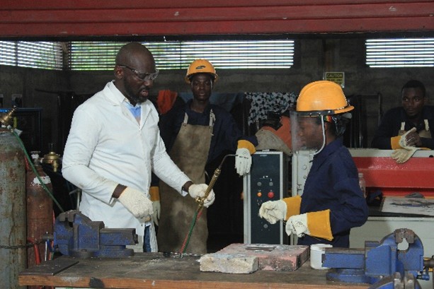 Instructor demonstrating gas cutting to a group of trainees