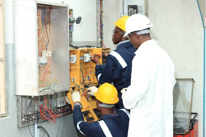 Trainees wiring a distribution board under instructor supervision