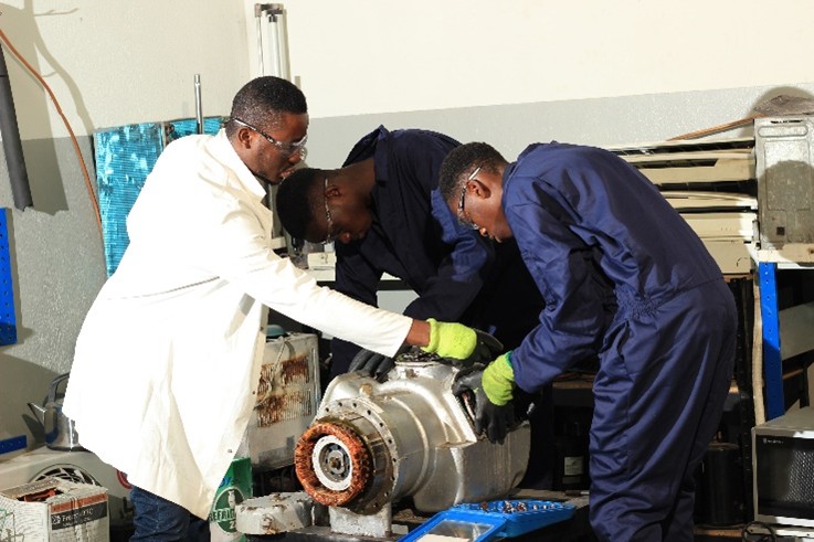 Instructor and trainees dismantling a compressor unit